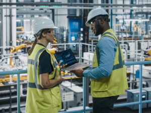 Two engineers in hard hats talking